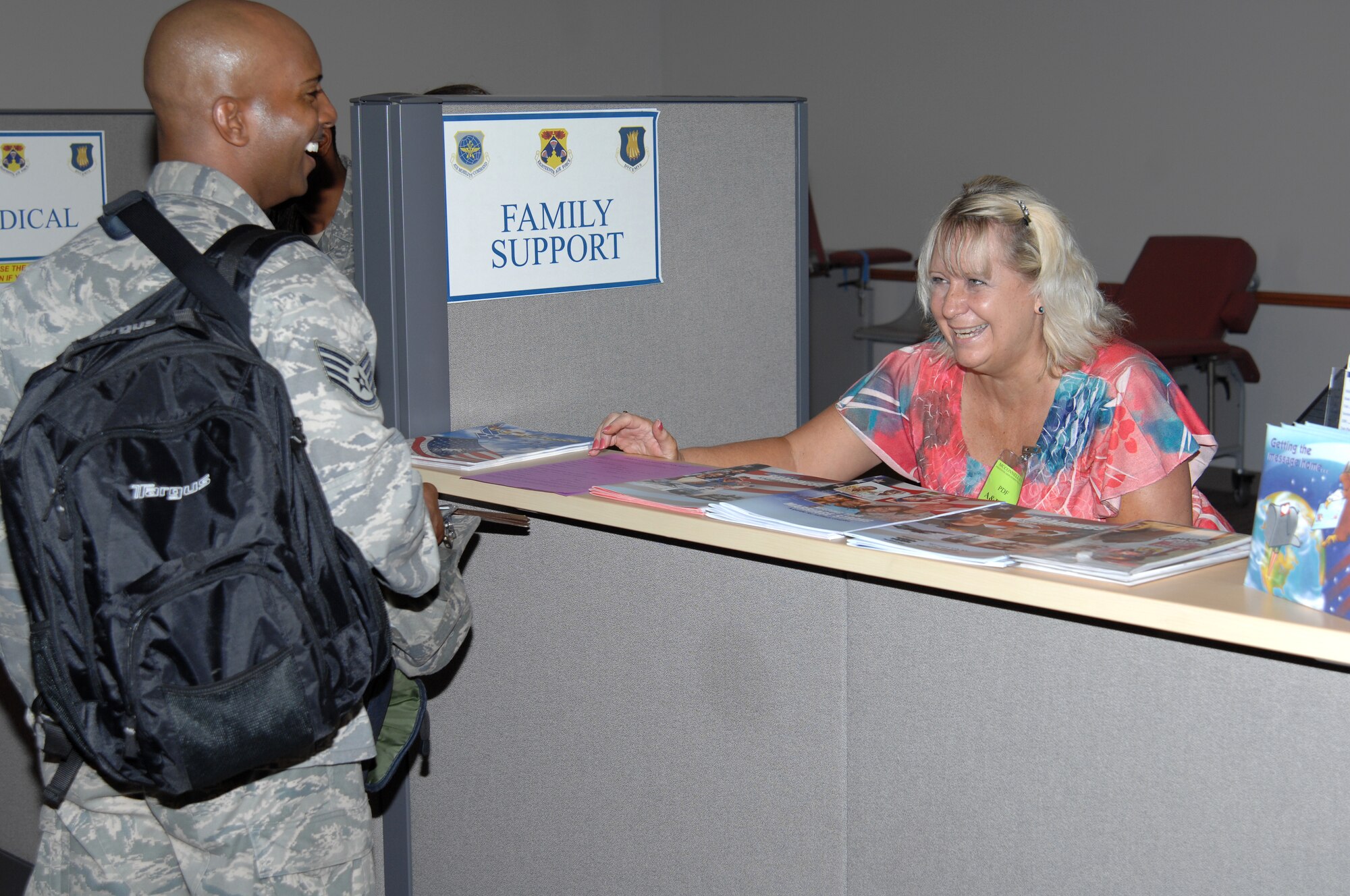 Maryann Barry, 22nd Force Support Squadron Airmen and Family Readiness Center community readiness consultant, explains to Staff Sgt. Sidney Okagu, 22nd Air Refueling Wing Command Post comptroller, some of the services provided to deploying Airmen during an exercise, Aug. 15, 2010, McConnell Air Force Base, Kan.  Exercises, like these, help to keep Team McConnell Airmen ready to mobilize on a moment’s notice. (U.S. Air Force photo/Staff Sgt. Ronald Lafosse)
