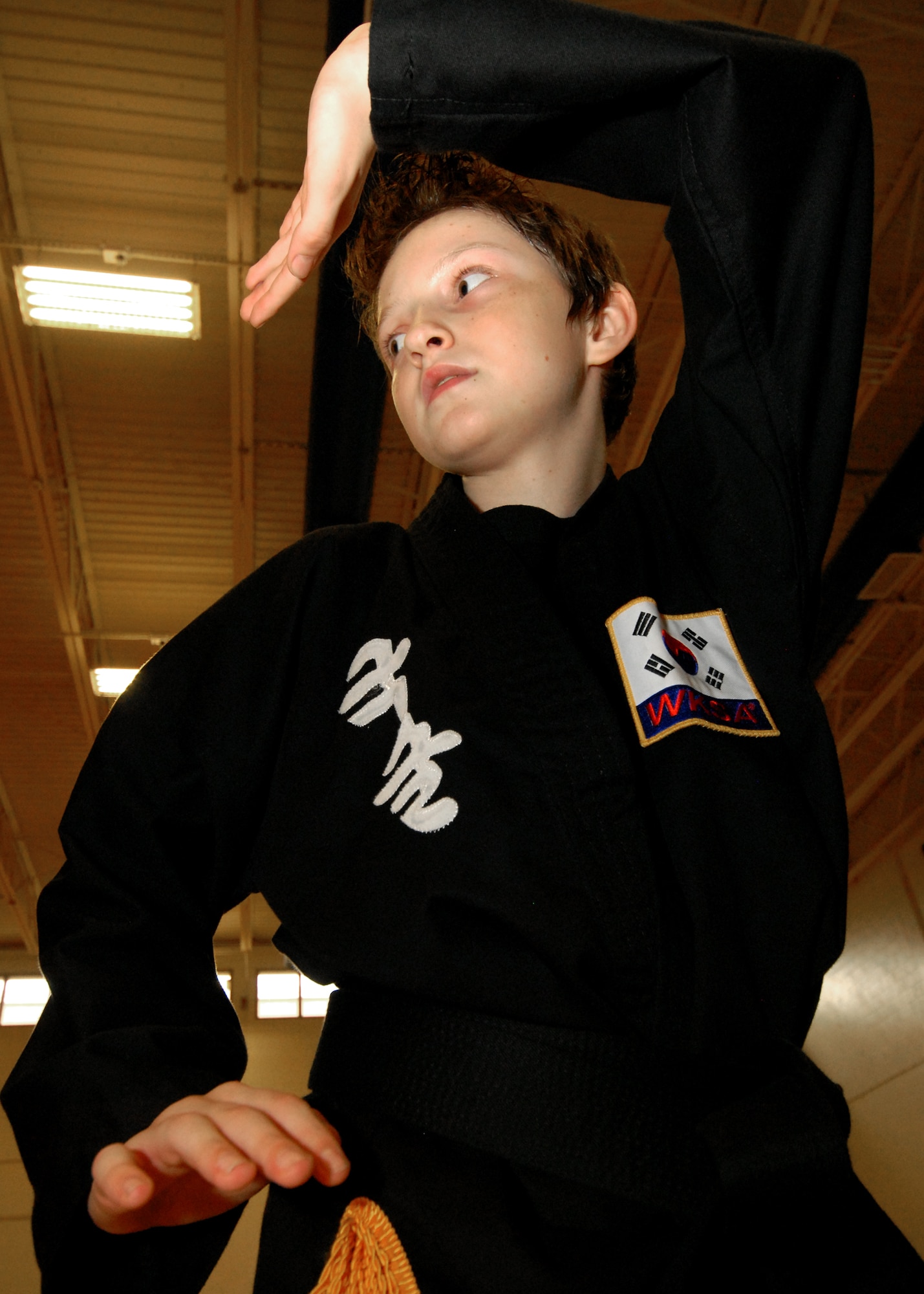 Ryan Schweitzer, works through a technique during Kuk Sool Won class at Eglin Air Force Base, Fla.  Schweitzer, son of Master Sgt. Kevin Schweitzer, 1st Special Operations Maintenance Squadron, earned his black belt in June.  The 12-year-old has been training for four years.  Kuk Sool Won encompasses many different "styles" of traditional martial arts.  It combines kicking, punching, throwing, falling, and joint-locking as well as a myriad of weapons techniques into a dynamic 'hard-soft' style, emphasizing speed and fluidity.  (U.S. Air Force photo by Samuel King Jr.)