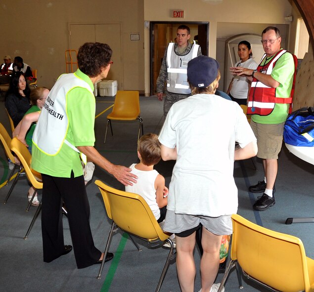 OFFUTT AIR FORCE BASE, Neb. - Larry Arp, a volunteer with the American Red Cross, assists families in the Emergency Family Assistance Center at the Bellevue Christian Center during Offutt's annual major accident response exercise here Aug. 14. The exercise tested the base's emergency response capabilities during a simulated aircraft accident. Military and local organizations from across the Omaha metro area worked together to respond to the disaster. U.S. Air Force photo by Jeff W. Gates