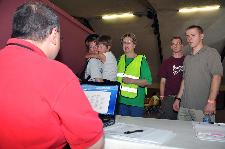 OFFUTT AIR FORCE BASE, Neb. - Jeffrey Hildenbrandt, an American Red Cross volunteer, assists families in the Emergency Family Assistance Center staging area at the Bellevue Christian Center during Offutt's annual major accident response exercise here Aug. 14. The exercise tested the base's emergency response capabilities during a simulated aircraft accident. Military and local organizations from across the Omaha metro area worked together to respond to the disaster. U.S. Air Force photo by Jeff W. Gates