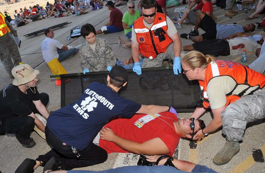 OFFUTT AIR FORCE BASE, Neb. - Emergency personnel from Offutt and Plattsmouth, Neb., provide care to Chris Bush, an Omaha native who volunteered to be a simulated victim during Offutt's annual major accident response exercise here Aug. 14. The exercise tested the base's emergency response capabilities. Military and local organizations from across the Omaha metro area worked together to respond to the simulated aircraft accident. U.S. Air Force photo by Jeff W. Gates