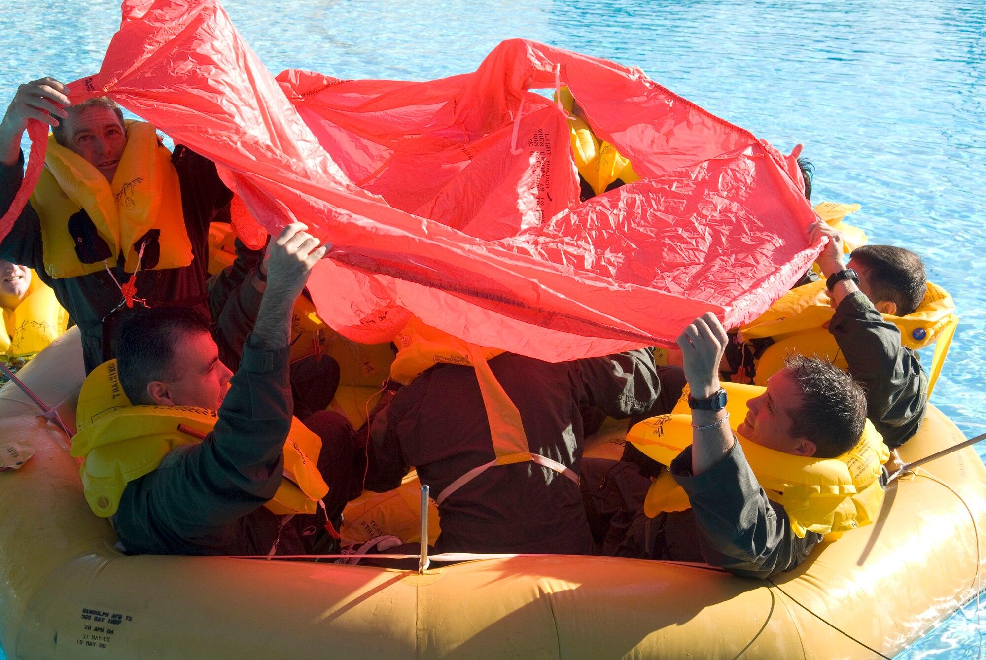 T-1A Jayhawk instructor pilots attach the roof on their nine-man raft during water survival refresher training Aug. 6, 2010, at Randolph Air Force Base, Texas. (U.S. Air Force photo/Steve White) 