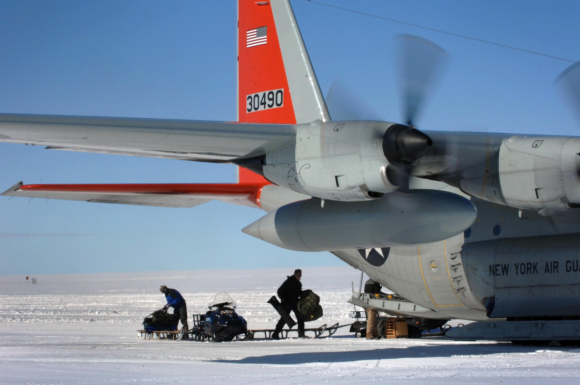 Supplies are loaded from a sled onto a ski-quipped LC-130 Hercules July 28, 2010, at a remote science research outpost in Greenland. The New York Air National Guard's 109th Airlift Wing is the only military unit in the world to fly such aircraft and has flown missions to Greenland since 1975. The unit now provides airlift support to National Science Foundation's polar research program there. (Department of Defense photo/Fred W. Baker III)