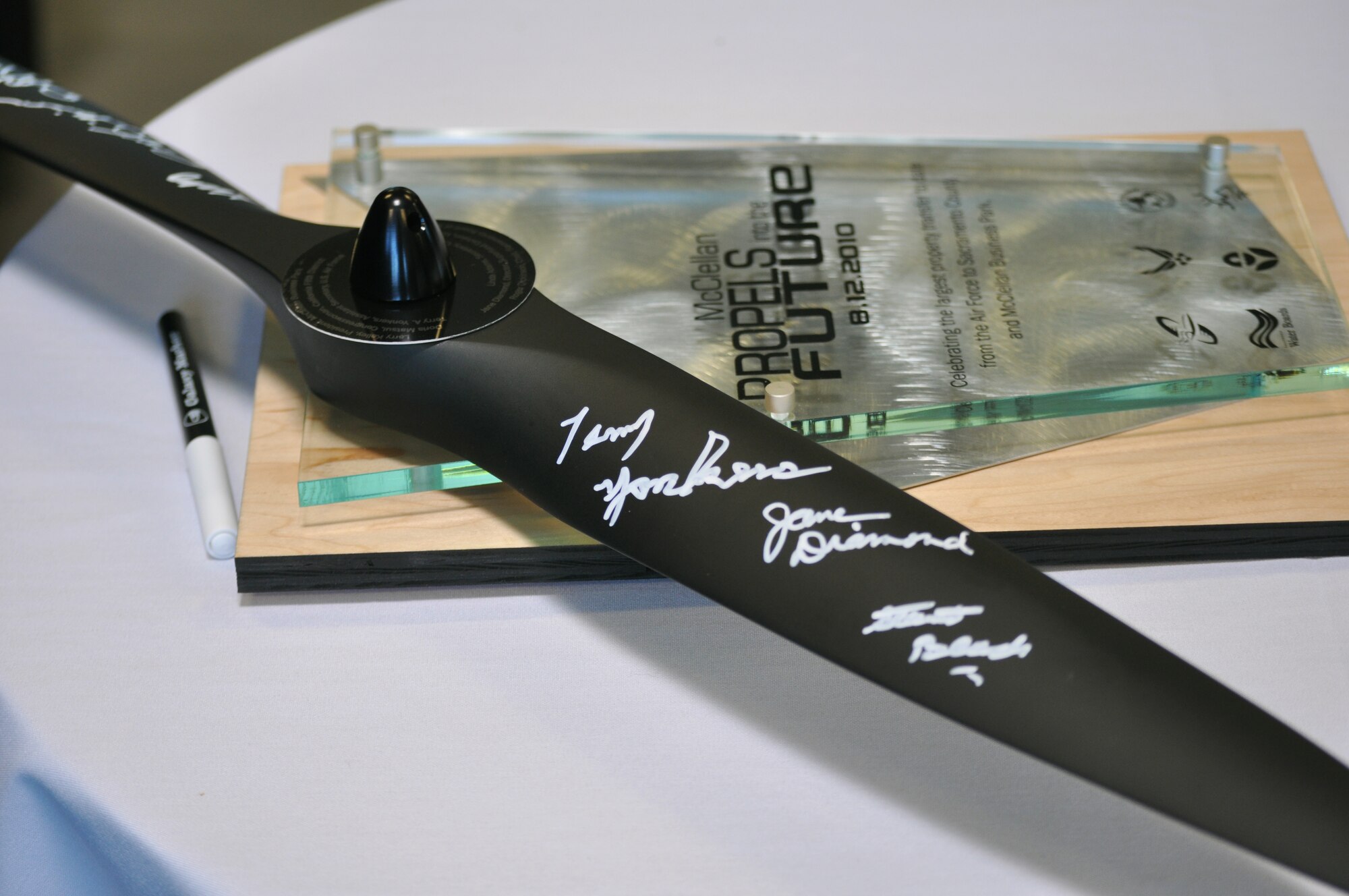 Official signatures on an aircraft propeller “seal the deal” Aug. 12, 2010, for the transfer of 560 acres from the Air Force to Sacramento County at the former McClellan Air Force Base in Sacramento, Calif. The inscription reads: Celebrating the largest property transfer to date from the Air Force to Sacramento County and McClellan Business Park. (U.S. Air Force photo)