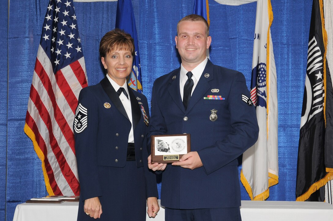 McGHEE TYSON AIR NATIONAL GUARD BASE, Tenn. - Senior Airman Casey W. Blystone, right, receives the distinguished graduate award for Airman Leadership School Class 10-5 at The I.G. Brown Air National Guard Training and Education Center here from Chief Master Sgt. Denise Jelinski-Hall, Aug. 12, 2010.  The distinguished graduate award is presented to students in the top ten percent of the class.  It is based on objective and performance evaluations, demonstrated leadership, and performance as a team player. (U.S. Air Force photo by Master Sgt. Kurt Skoglund/Released)
