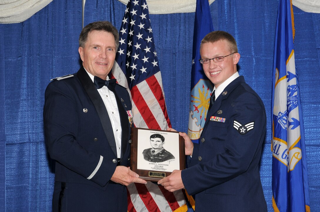 McGHEE TYSON AIR NATIONAL GUARD BASE, Tenn. - Senior Airman Nicholas A. Adkins, right, receives the John L. Levitow honor award for Airman Leadership School Class 10-5 at The I.G. Brown Air National Guard Training and Education Center here from Col. Richard B. Howard, TEC commander, Aug. 12, 2010.  The John L. Levitow award is the highest honor awarded a graduate of any Air Force enlisted professional military education course.  (U.S. Air Force photo by Master Sgt. Kurt Skoglund/Released)