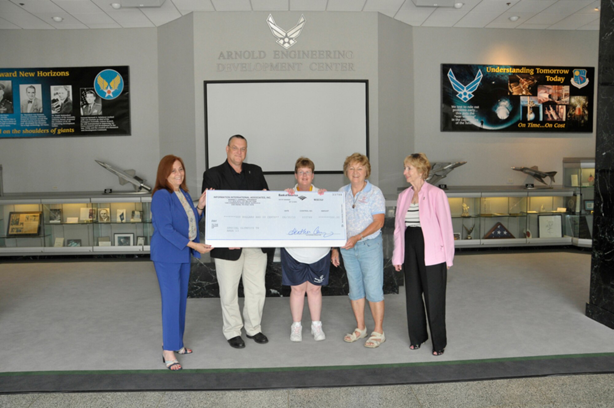 Information International Associates (IIa), Inc. presents a $500 donation to Special Olympics Area 13. Pictured, left to right are Bonnie Carroll, IIA president; Kent Turner, IIA project manager at AEDC; Special Olympian Shawna Eifert of Tullahoma; Karen Matchett, volunteer director for Special Olympics Area 13; and Patricia Powell, IIA senior vice president. (Photo by Rick Goodfriend)

