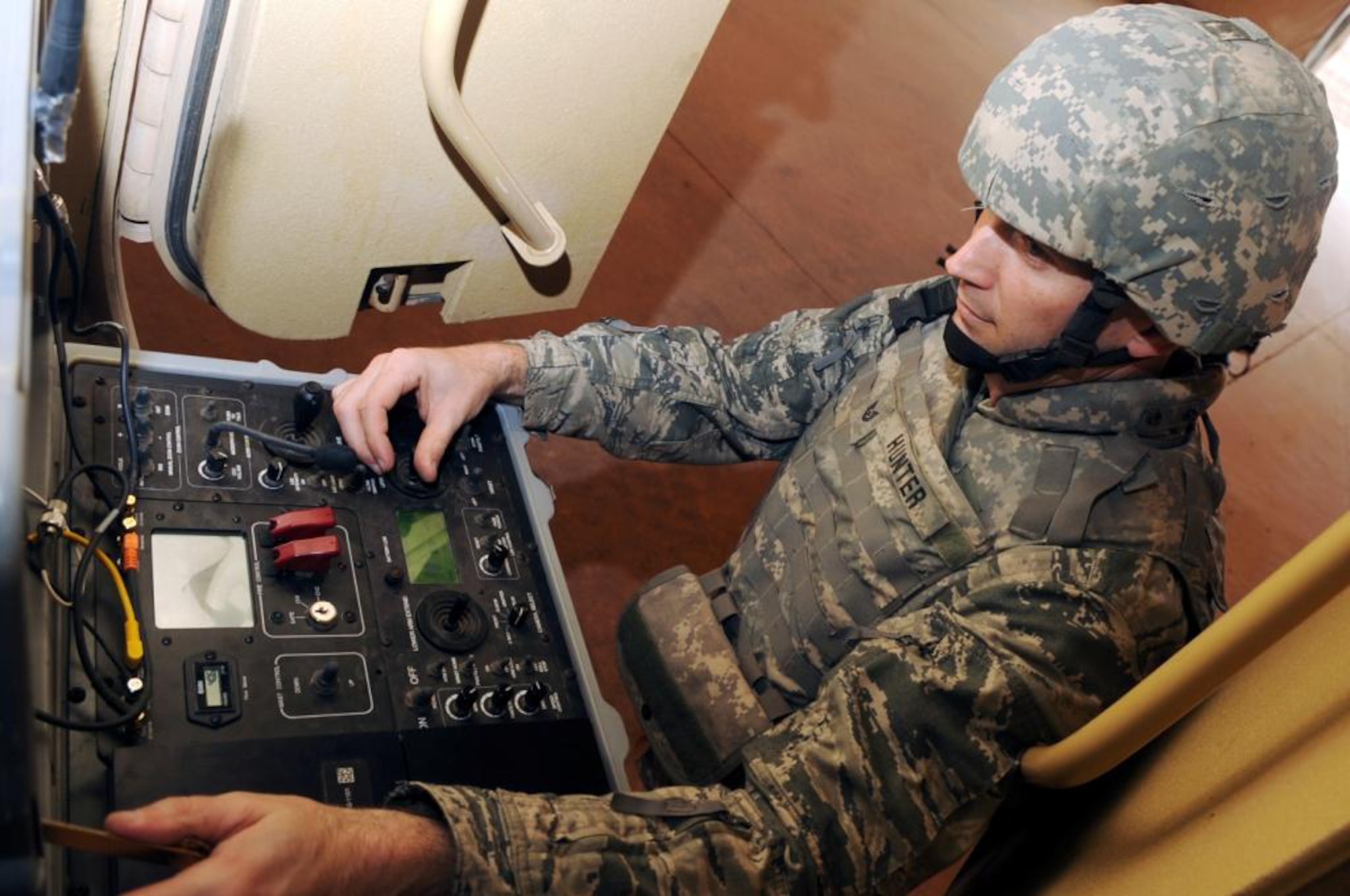 Tech. Sgt. Stephen R. Hunter Jr., 944th Civil Engineer Squadron explosive ordnance disposal craftsman from Luke Air Force Base, Ariz., operates the controls of the Talon robot while deployed to Joint Base Balad, Iraq. Sergeant Hunter is one of the Air Force?s 12 Outstanding Airmen of the Year for 2010. (Courtesy photo)