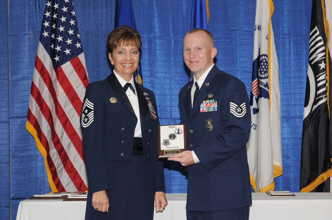 McGHEE TYSON AIR NATIONAL GUARD BASE, Tenn. -- Tech. Sgt. Stephen W. Hudson, right, receives the distinguished graduate award for NCO Academy Class 10-7 at The I.G. Brown Air National Guard Training and Education Center here from Chief Master Sgt. Denise Jelinski-Hall, Aug. 12, 2010.  The distinguished graduate award is presented to students in the top ten percent of the class.  It is based on objective and performance evaluations, demonstrated leadership, and performance as a team player. (U.S. Air Force photo by Master Sgt. Kurt Skoglund/Released)