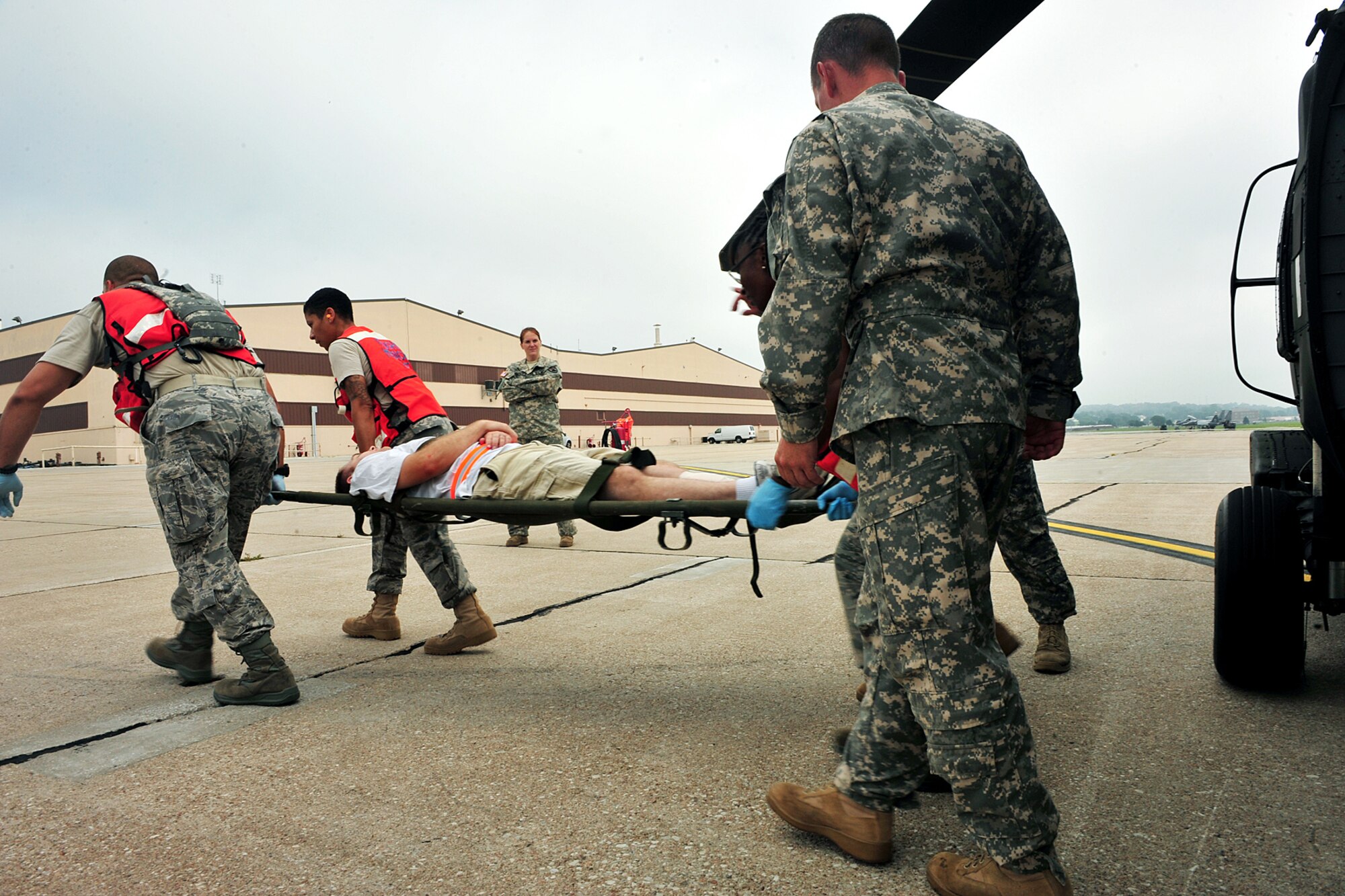 OFFUTT AIR FORCE BASE, Neb. - Team Offutt members from the 55th Medical Group unload volunteers with simulated injuries into two UH-60 Blackhawk helicopters on the flight line Aug. 14 as part of a major accident response exercise. Airmen with the 55th Medical Group along with medical professionals from the surrounding Omaha metro area take part in this annual exercise in anticipation of the Defenders of Freedom Open House and Air Show hosted here. U.S. Air Force Photo by Charles Haymond