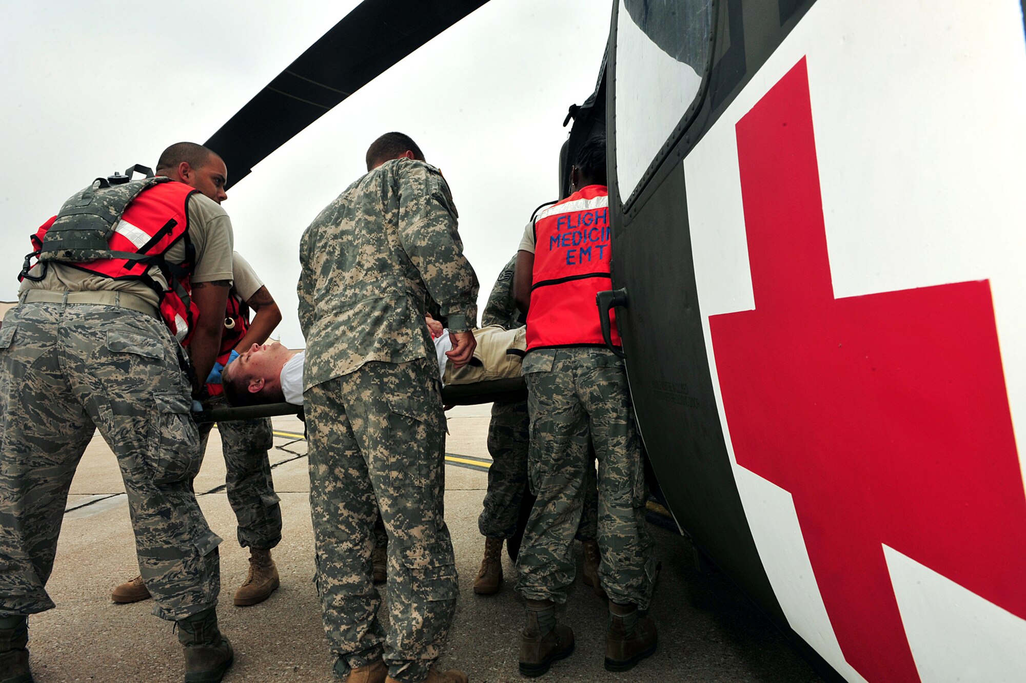 OFFUTT AIR FORCE BASE, Neb.- Airman with the 55th Medical Group work in conjunction with Soldiers from the Lincoln National Guard to unload volunteers posing as severely injured civilians out of an awaiting UH-60 Blackhawk helicopter as part of a joint Major Accident Response Exercise August 14. Airmen with the 55th Medical Group along with medical professionals from the surrounding Omaha metro area take part in a mare held annually prior to the Defenders of Freedom Air Show hosted here. U.S. Air Force Photo by Charles Haymond