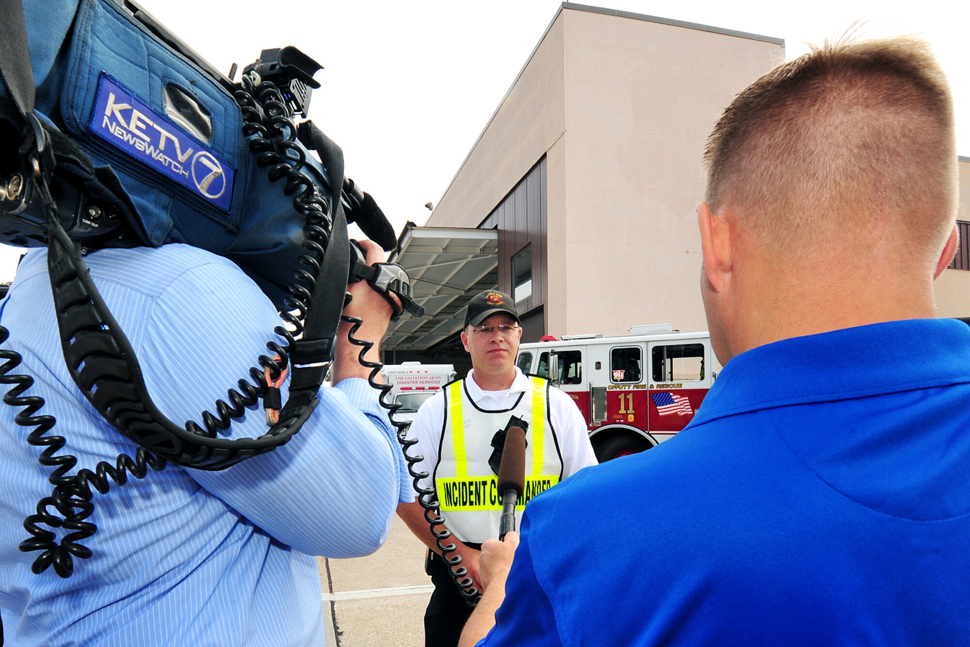 OFFUTT AIR FORCE BASE, Neb. - Jeff Van Sant, KETV-7 reporter, and Ryan Hansen, 55th Wing Public Affairs,  interview Todd Kiesel, 55th Civil Engineer Squadron assistant fire chief and incident commander, during a major accident response exercise August 14. Airmen with the 55th Medical Group along with medical professionals from the surrounding Omaha metro area respond to a simulated aircraft accident in this annual exercise to prepare the Defenders of Freedom Open House and Air Show hosted here. U.S. Air Force photo by Charles Haymond