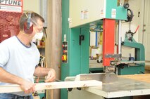 Sergeant Gary Tumminia prepares a piece of wood in his woodworking shop at home. (USAF photo by SSgt. Terrica Jones, 916PA)