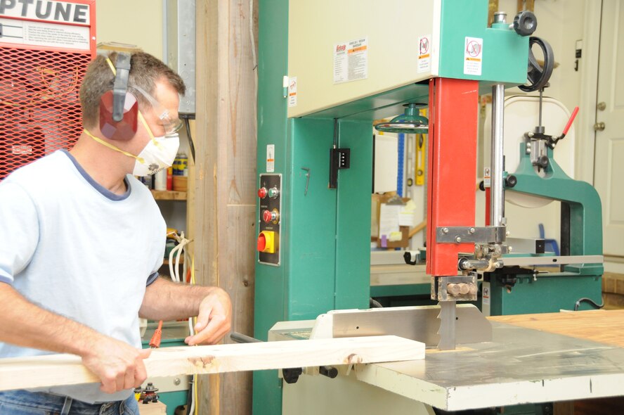 Sergeant Gary Tumminia prepares a piece of wood in his woodworking shop at home. (USAF photo by SSgt. Terrica Jones, 916PA)