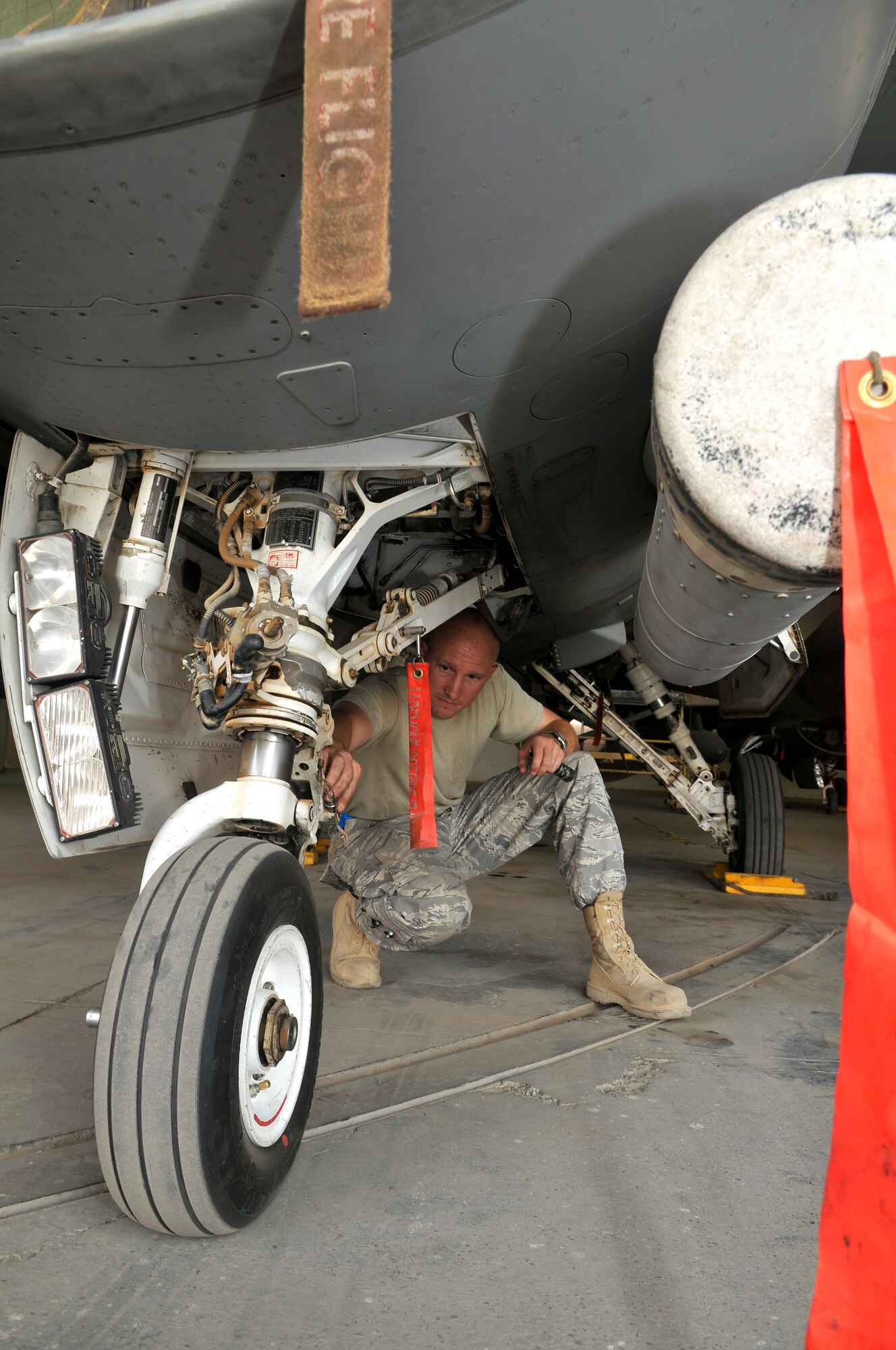 Master Sgt. Jesse Mathes, 332nd Expeditionary Aircraft Maintenance Squadron Viper Aircraft Maintenance Unit production superintendant, examines a nose gear torque-link pin for serviceability on an F-16 Fighting Falcon during an exceptional release inspection Aug. 6, 2010, Joint Base Balad, Iraq. Torque-links help keep the nose landing gear strut from separating from the rest of the aircraft.  The F-16 has a tri cycle type landing gear system, with to main wheels in the back and one wheel infront. Sergeant Mathes, a native of Gate City, Va., is deployed from Shaw Air Force Base, S.C. (U.S. Air Force photo/staff Sgt. Phillip Butterfield)