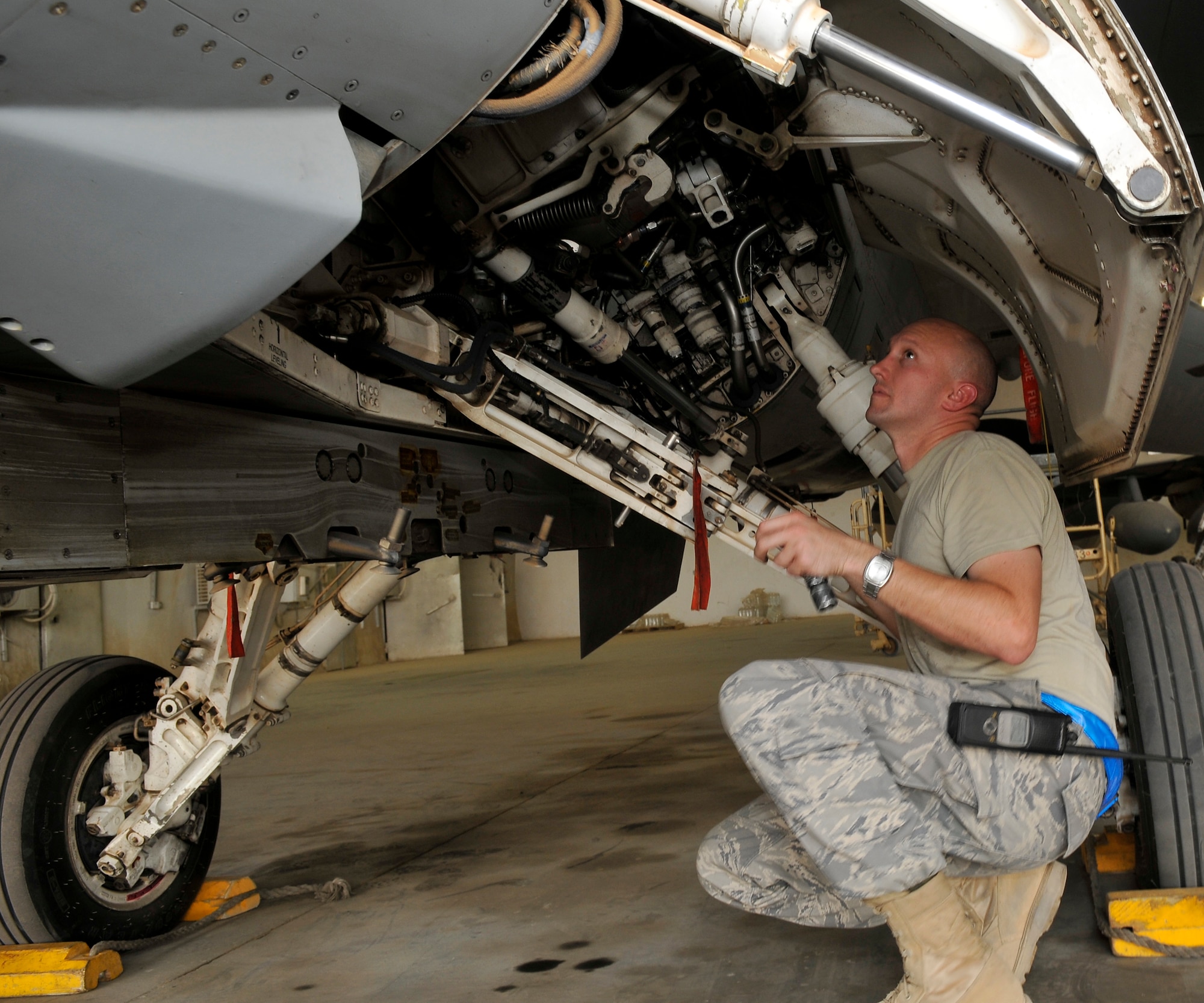 Master Sgt. Jesse Mathes, 332nd Expeditionary Aircraft Maintenance Squadron Viper Aircraft Maintenance Unit production superintendant, scrutinizes all the piping, wire harnesses and hydraulics in the left main landing compartment on an F-16 Fighting Falcon during an exceptional release inspection Aug. 6, 2010, Joint Base Balad, Iraq. Overlooked discrepancies may prove to be disastrous to mission success, hence this extra inspection. Sergeant Mathes, a native of Gate City, Va., is deployed from Shaw Air Force Base, S.C. (U.S. Air Force photo/staff Sgt. Phillip Butterfield)
