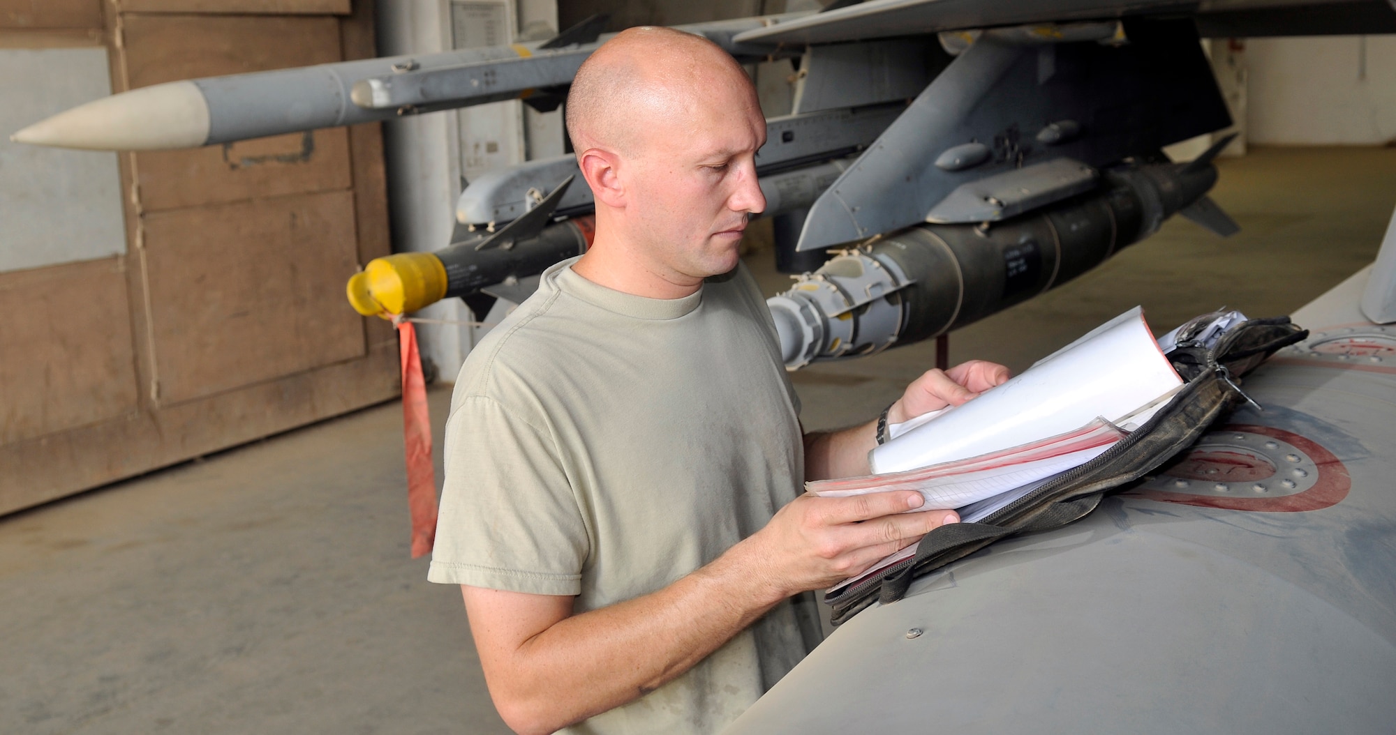 Master Sgt. Jesse Mathes, 332nd Expeditionary Aircraft Maintenance Squadron Viper Aircraft Maintenance Unit production superintendant, inspects the aircraft’s forms looking for jobs that have not been completed Aug. 6, 2010, Joint Base Balad, Iraq. Checking the forms is the first step in performing an exceptional release inspection. An exceptional release is an inspection performed by production supervisors. During this inspection, the aircraft and its forms are scrutinized for any noticeable aircraft defects or documentation errors. Sergeant Mathes, a native of Gate City, Va., is deployed from Shaw Air Force Base, S.C. (U.S. Air Force photo/staff Sgt. Phillip Butterfield)