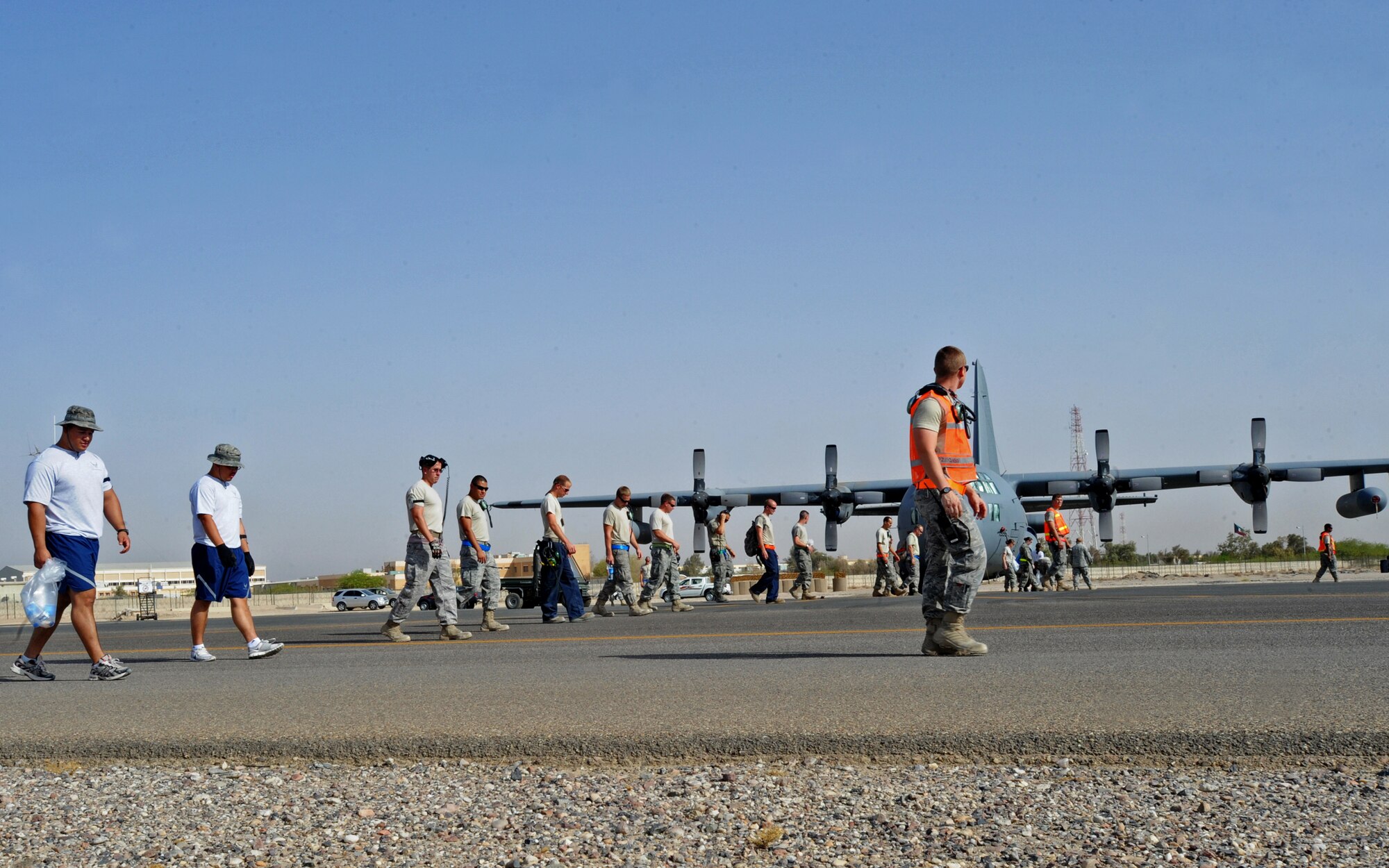 SOUTHWEST ASIA -- Approximately 250 Airmen from the 386th Air Expeditionary Wing collect Foreign Object Debris on the base airfield here during the quarterly FOD walk Aug. 14, 2010. The volunteers scoured maintenance areas and taxiways, collecting 35 pounds of trash that could cause serious damage if ingested into aircraft engines. (U.S. Air Force photo by Senior Airman Laura Turner)
