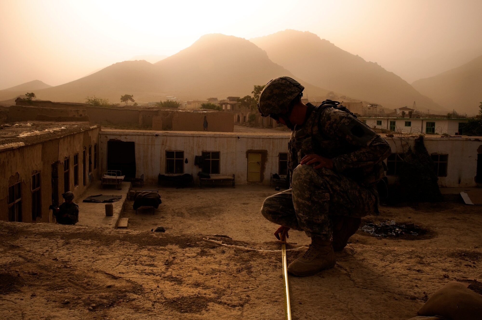 COMBAT OUTPOST MIZAN, Afghanistan -- U.S. Army Pfc. Joshua Murphy, rifleman for Provincial Reconstruction Team Zabul and New Brighton, Pa. native, measures a rooftop of a school near Combat Outpost Mizan, Zabul Province, Aug. 14, 2010. PRT Zabul is working to renovate the school as part of an ongoing effort to improve Mizan District. (U.S. Air Force photo/Senior Airman Nathanael Callon/Released)