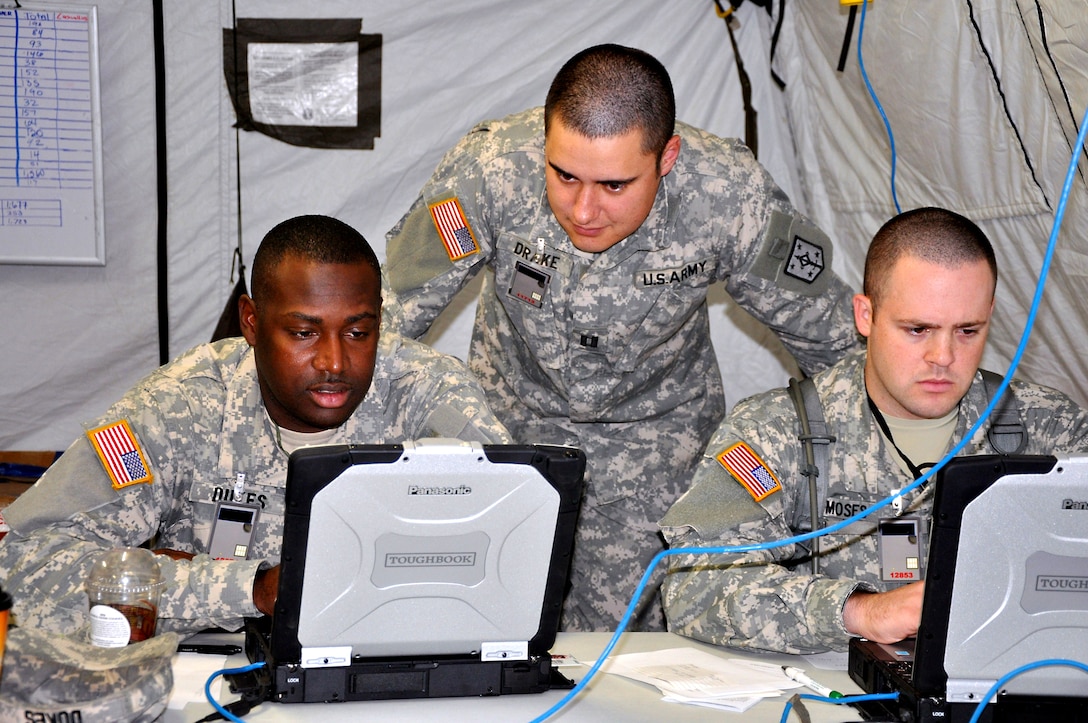 Left to right,  U.S. Army Sgt. 1st Class Everett Dukes, Capt. Christopher Drake and Capt. Benjamin Moses work on the Vibrant Response 11.1 Task Force Operations Command update power point slides for the Tactical Operation Center's medical section at the Fort Leavenworth Battle Command Training Center, Kan., Aug. 15, 2010.

