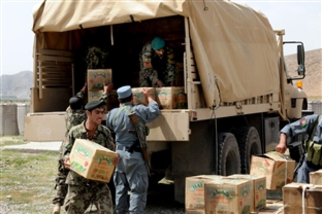 Afghan National Security Forces unload relief supplies for flood victims in the Musahi municipality, just outside of Kabul, Afghanistan, Aug. 15, 2010. Flooding hit the area recently forcing many from their homes and damaging the crop for the year. Various supplies distributed to families included shelter, cooking tools, food and clothing.