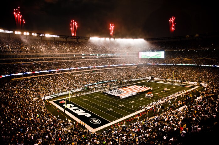 Marines, sailors, Coast Guardsmen, airmen and soldiers unfurled an American flag across the field during a pre-game ceremony before the New York Jets vs. New York Giants game Aug. 16, 2010, in East Rutherford, N.J. The game was the first football game in New Meadowlands Stadium, the newly built home of both the New York Giants and the New York Jets.