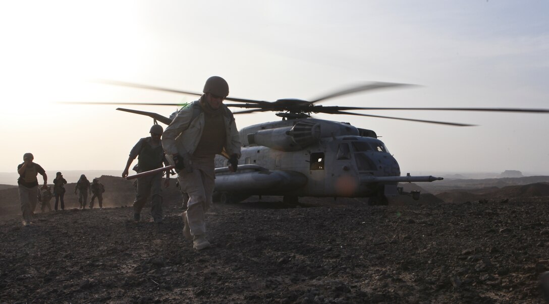 A CH-53E Super Stallion from Marine Heavy Helicopter Squadron 361, 3rd Marine Aircraft Wing (Forward), inserts a team of geologists working for The Task Force for Business and Stability Operations at helicopter landing zone Barton in support of Operation Centrum, Aug. 16. Sixteen Marines and one Navy corpsman from the 1st Marine Division (Fwd)'s Personal Security Detachment escorted the six geologists as they excavated rock samples from the area in search of rare valuable earth elements and industrial minerals.  3rd MAW (Fwd)’s support allowed the geologists to remove about 200 pounds of samples for further testing.