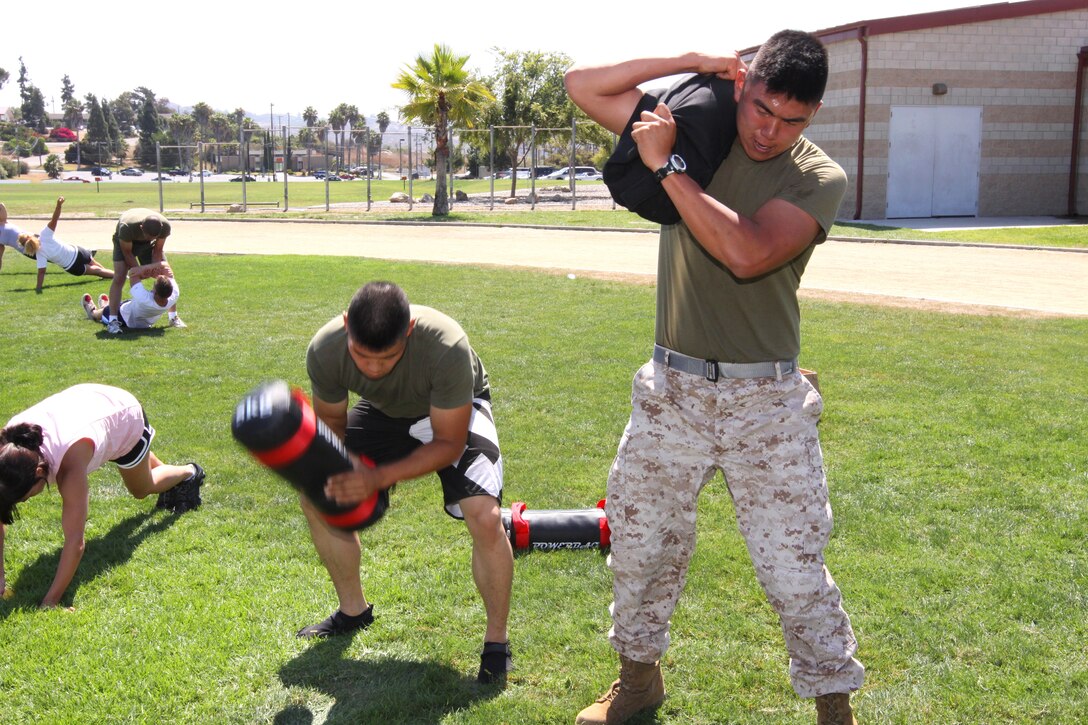 Cpl. Tyler Kim (left), and Cpl. Matthew H. Kim, riflemen, with 4th Light Armored Reconnaissance Battalion, 4th Marine Division, are training for the Combat Fitness Test by conducting a combat conditioning course at Camp Pendleton’s Paige Fieldhouse, Aug. 16. The Physical Fitness Test and the CFT are the two tests used by the Marine Corps to evaluate Marines’ physical readiness.