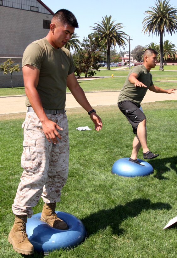 Lance Cpl. Simon Kim (left), and Cpl. Tyler Kim, riflemen, with 4th Light Armored Reconnaissance Battalion, 4th Marine Division, are training for the Combat Fitness Test by conducting a combat conditioning course at Camp Pendleton’s Paige Fieldhouse, Aug. 16. The Physical Fitness Test and the CFT are the two tests used by the Marine Corps to evaluate Marines’ physical readiness.