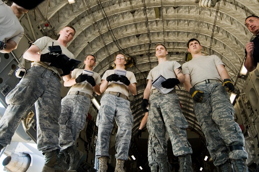 Airmen listen for instruction before participating in the hands-on portion of aerial port expeditor training Aug. 17, 2010, at Joint Base Lewis-McChord, Wash. (U.S. Air Force Photo/Abner Guzman) 
