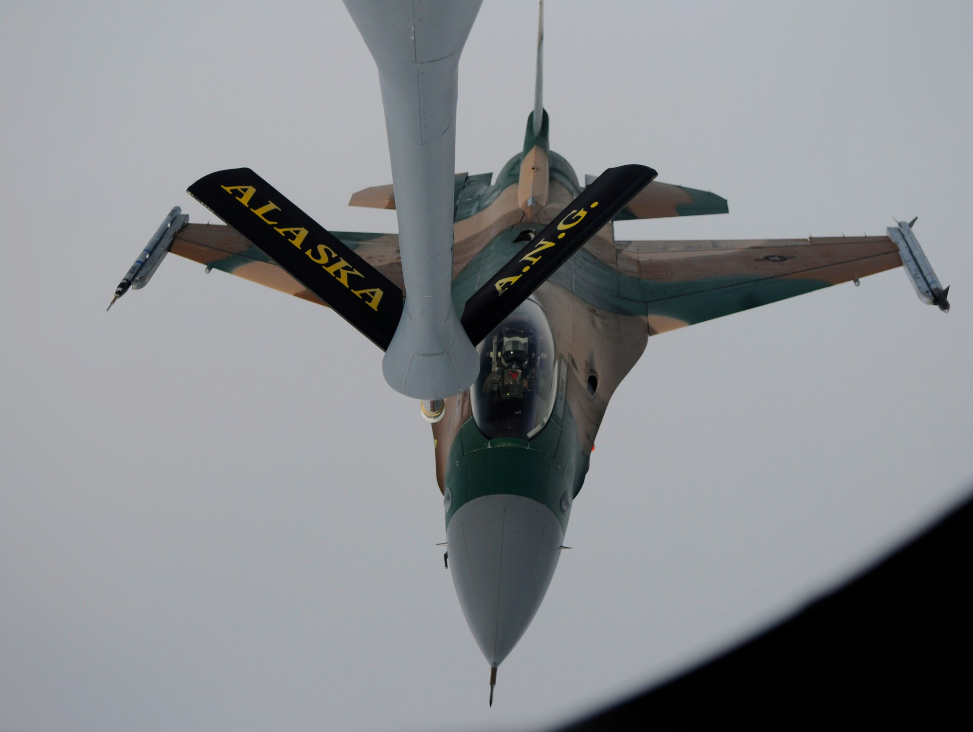 An F-16 Aggressor trails beneath a KC-135 Stratotanker as it prepares to refuel August 13, 2010, Eielson Air Force Base, Alaska. The 168th Air Refueling Wing  mission is to train and equip KC-135R combat crews to provide air refueling in support of PACAF Operations Plans and worldwide refueling taskings.  Red Flag Alaska serves as an opportunity to train tankers and guardsmen to fulfill the PACAF mission. (U.S. Air Force photo/Airman 1st Class Yash Rojas) 