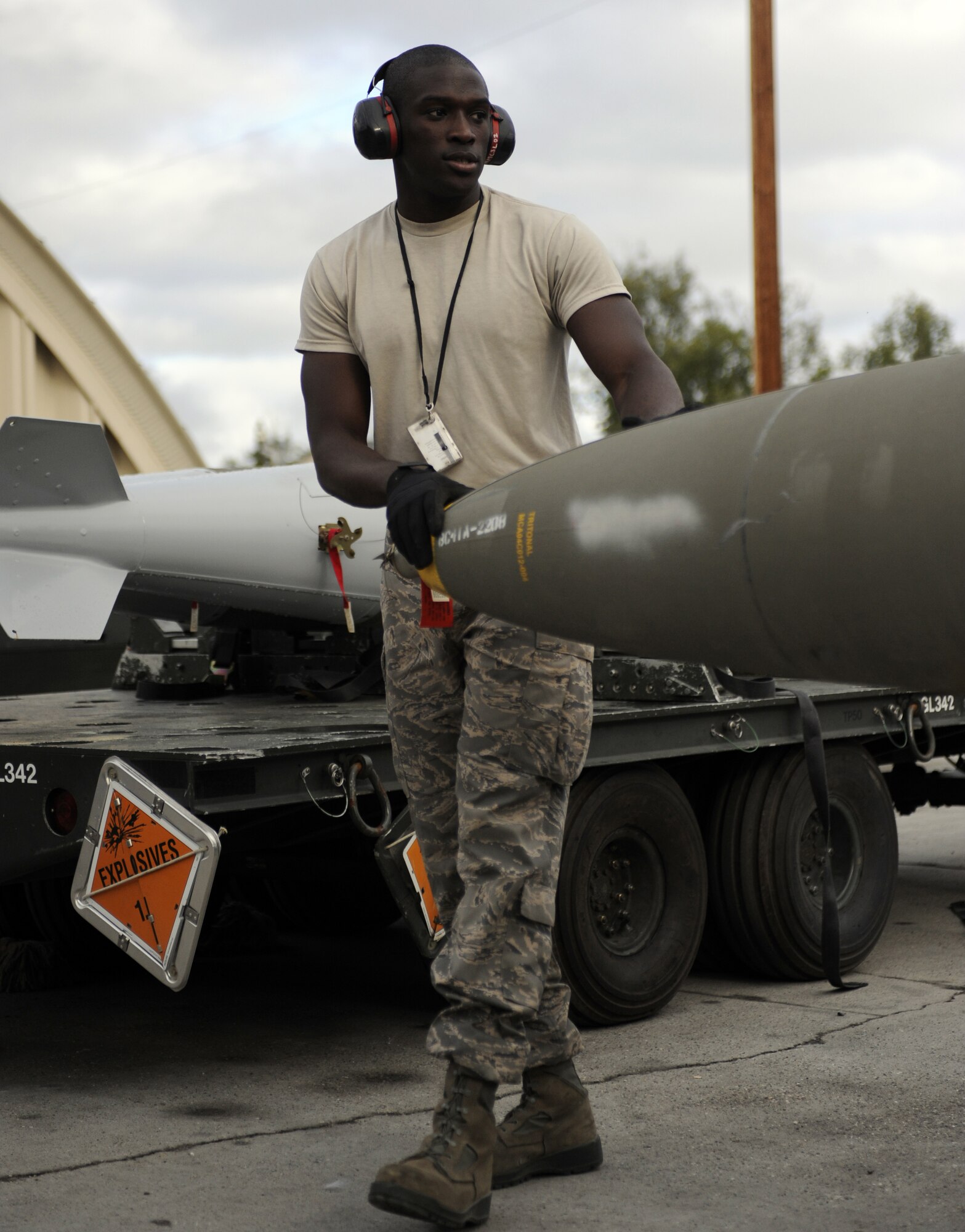 Senior Airman Sean Scarber guides a GBU-38 JDAM Precision Guided Bomb onto a trailer August 13, 2010, Eielson Air Force Base, Alaska. The Conventional Maintenance Element is responsible for building, loading, and delivering all the different bombs and munitions flown by home station and temporary duty units.  The 354th Munitions Flight handles bombs ranging from 25-2000 lbs, and can be laser guided or "dumb" bombs. Airman Scarber is a Munitions Storage Crew Chief assigned to Osan Air Base, Korea. (U.S. Air Force photo/Senior Airman Willard E. Grande II)