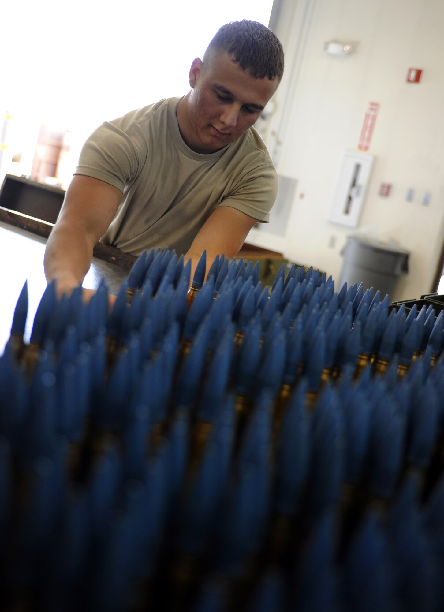 Airman Kevin Gibson counts 20mm ammunition August 13, 2010, Eielson Air Force Base, Alaska. Units at Eielson on temporary duty bring their allocation with them and can expend over 20,000 rounds during a typical Red Flag-Alaska exercise.  Each round is counted, inspected and loaded into the Universal Ammunitions Loading Assembly (UALS) by hand before it is towed to the flightline to be loaded into the jet. Airman Gibson is a Conventional Maintenance Crew Member assigned to the 354th Munitions Flight. (U.S. Air Force photo/Senior Airman Willard E. Grande II)