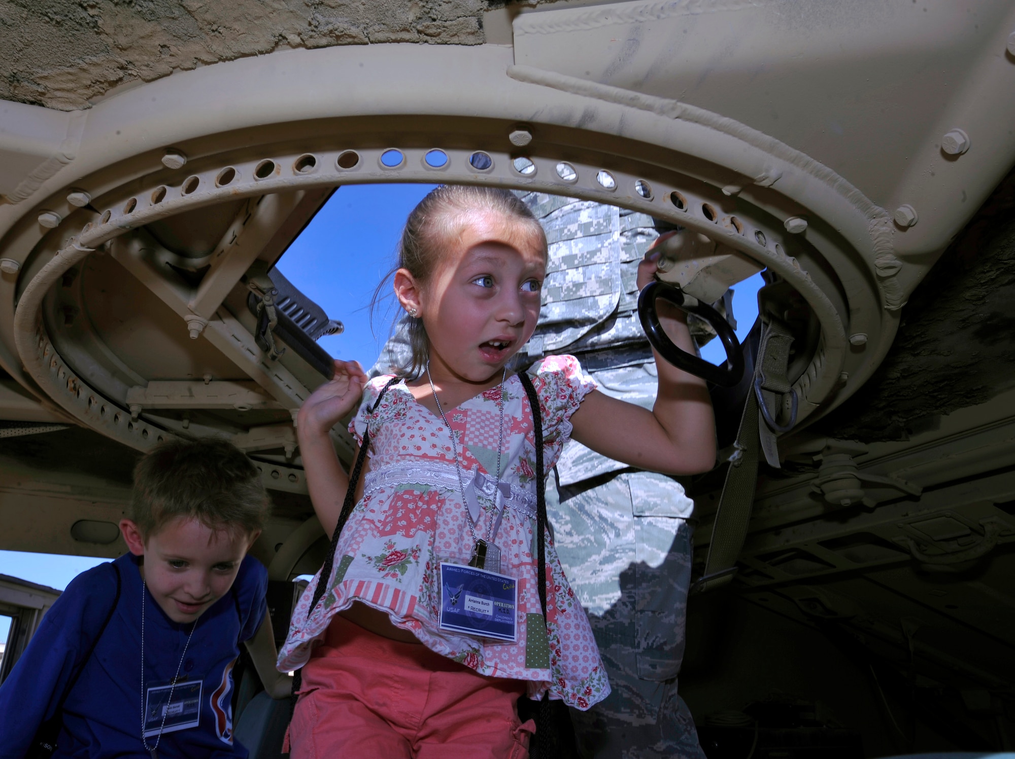 HOLLOMAN AIR FORCE BASE, N.M. -- Arrianna Burch, daughter of Senior Airman James Hastings, 49th Material Maintenance Squadron, takes a look inside a High Mobility Multipurpose Wheeled Vehicle, also known as a HUMVEE, during Operation K.I.D.: Kids Investigating Deployment, Aug. 12, 2010. Airmen from the 49th Security Forces Squadron showed kids the inside of a HUMVEE and talked to them about how they are used in a deployed location. The goal of Operation K.I.D. was to give children a better understanding of what their parents do when they deploy. (U.S. Air Force photo by Senior Airman Veronica Stamps / Released)