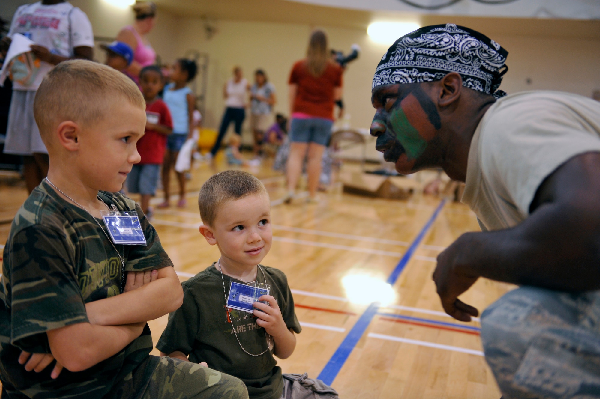 HOLLOMAN AIR FORCE BASE, N.M. -- 1st Lt. Brandon Sanders, Air Combat Command Training Support Squadron, gives Holloman children a pep talk at the Domenici Fitness and Sports Center before "deploying" during Operation K.I.D.: Kids Investigating Deployment, Aug. 12, 2010. More than 180 Team Holloman children had the opportunity to see what their parents do when they deploy during the event through hands on demonstrations and displays at the Basic Expeditionary Airfield Resources Base. (U.S. Air Force photo by Senior Airman Veronica Stamps / Released)