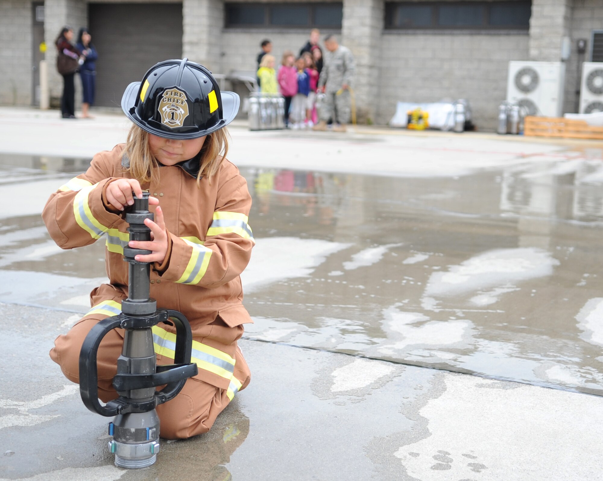 VANDENBERG AIR FORCE BASE, Calif. -- A participant at the Kids Fire Camp here attempts to reassemble a piece of a fire hose during the obstacle course here Saturday, Aug. 14, 2010. The annual Kids Fire Camp includes giving children the opportunity to use some of the many firefighting tools. (U.S. Air Force photo/Senior Airman Ashley Reed)