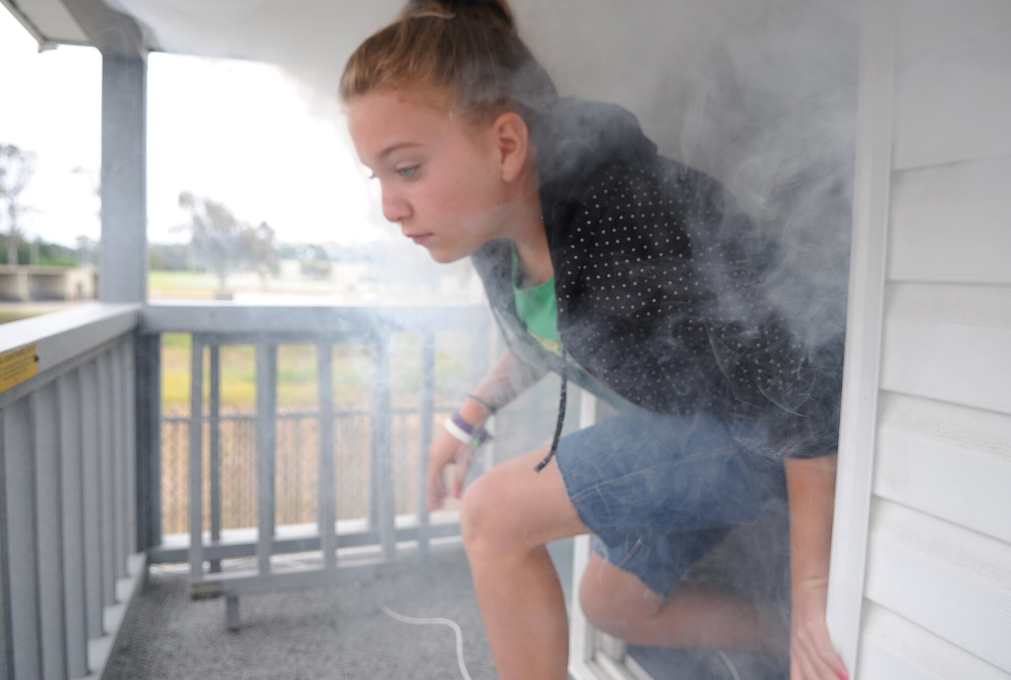 VANDENBERG AIR FORCE BASE, Calif. -- A local child here quickly exits a simulated house fire during the annual Kids Fire Camp here Saturday, Aug. 14, 2010. At this station, children were taught how to identify safety hazards around the house and how to escape a smoke filled house. (U.S. Air Force photo/Senior Airman Ashley Reed)