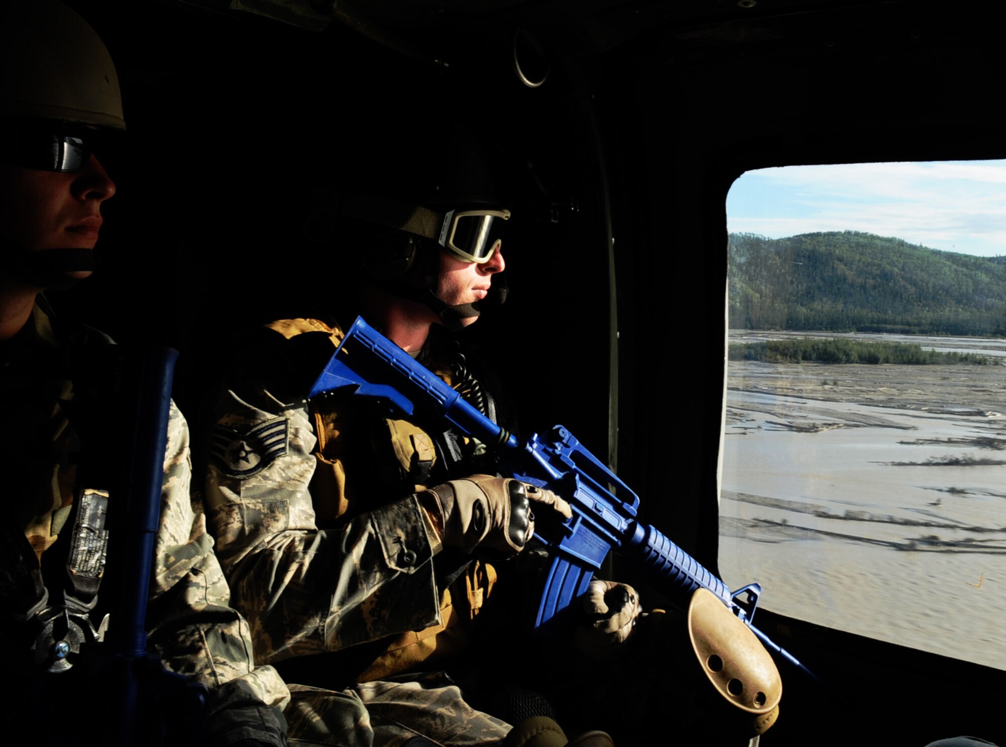 Airmen riding in the UH-60 Black Hawk fly over the Tanana river to set a tactical position in the Joint Pacific Alaskan Range Complex during Red Flag-Alaska 10-4, August 12, 2010, Eielson Air Force Base, Alaska. The joint terminal air controllers identify ground targets for close air support missions downrange. RF-A provides oppertunities to integrate joint, coalition and bilateral training from simulated forward operating bases that the 67,000 square mile Joint Pacific Alaska Range Complex has to offer. Sgt. Derra is assigned to the 25 Air Support Operations Squadron, Wheeler Army Air Field, Hawaii. (U.S. Air Force photo/Airman 1st Class Laura Goodgame) 