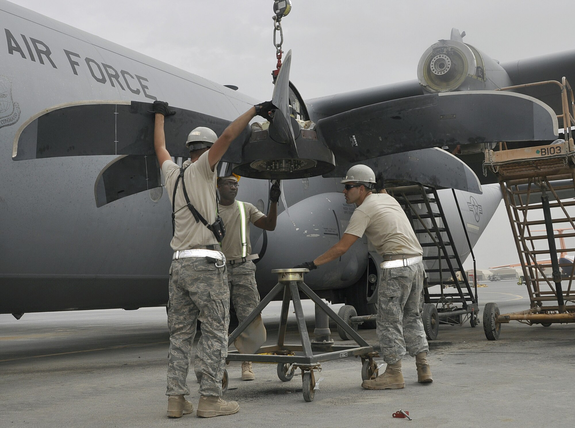 Members of the 451st Expeditionary Aircraft Maintenance Squadron remove a damaged propeller from a C-130J Hercules aircraft Aug. 8, 2010, at Kandahar Airfield, Afghanistan. (U.S. Air Force photo/Tech Sgt. Renni Thornton)