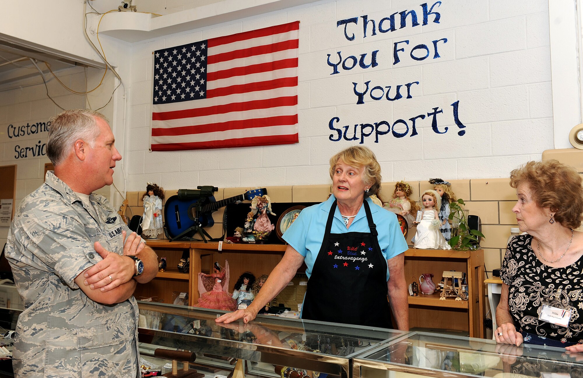 NELLIS AIR FORCE BASE, Nev.-- Col. Kevin Fox, 99th Mission Support Group commander, speaks with Dolores Harris and Hilde Jopes, volunteers at the Nellis thrift shop, about the renovations of the store Aug. 17. Mrs. Harris has been a thrift shop volunteer for 21 years and Mrs. Jopes has been volunteering for 30. The revenue from the thrift shop is donated to charities and scholarships for military personnel who are pursuing education. (U.S. Air Force Photo by Senior Airman Brett Clashman)
