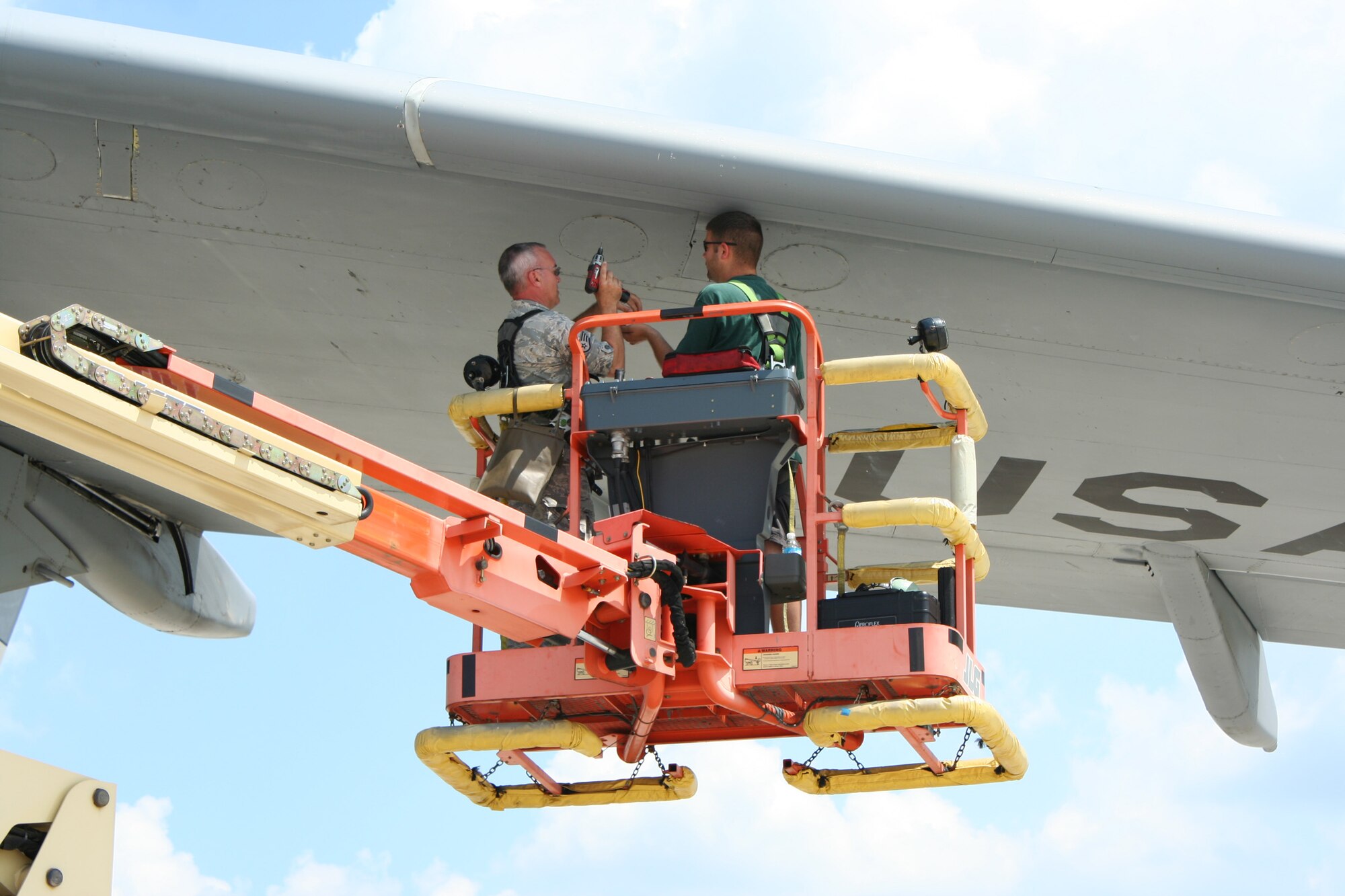 WRIGHT-PATTERSON AIR FORCE BASE, Ohio - Staff Sgt. Dan Rodgers and Senior Airman Michale Blake, both from the 445th Aircraft Maintenance Squadron, perform repair work underneath the wing of a C-5 Galaxy recently. (U.S. Air Force photo/Senior Airman Mikhail Berlin)