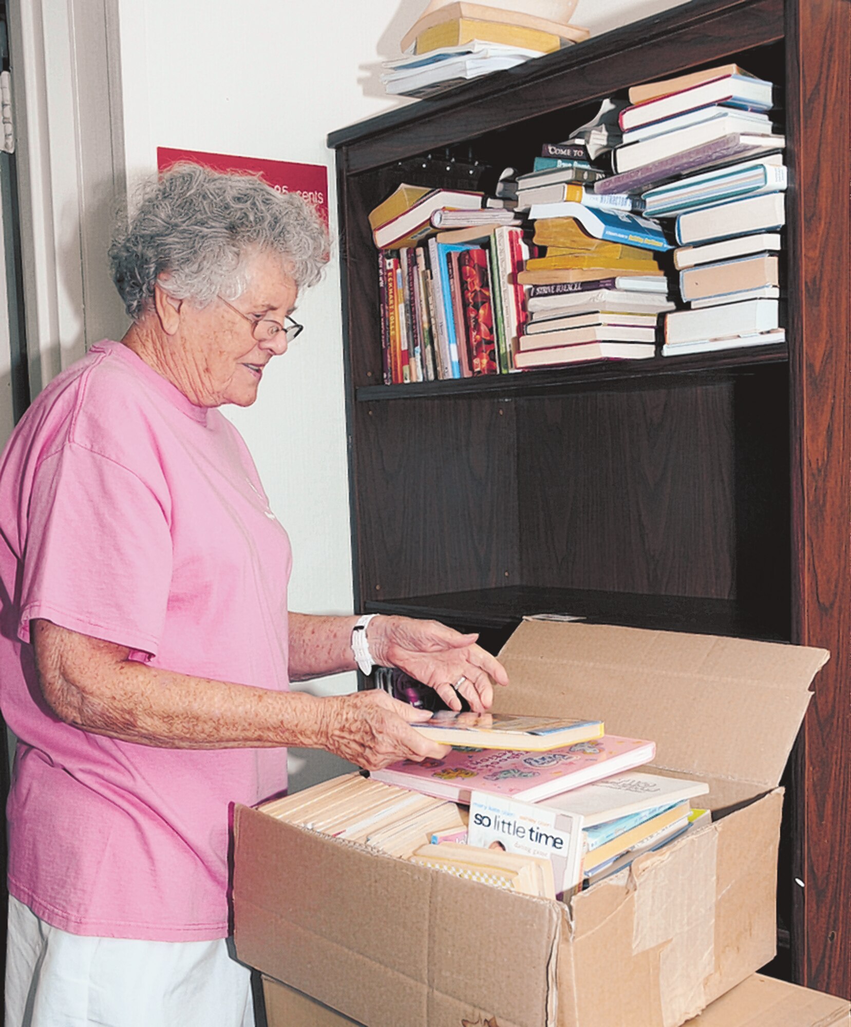 Kathy Varble, wife of retired Lt. Col. Thomas Varble, packs up used books to be moved to their new shelves at the old garden center, Keesler Thrift Shop’s new home.  (U.S. Air Force photo by Kemberly Groue)