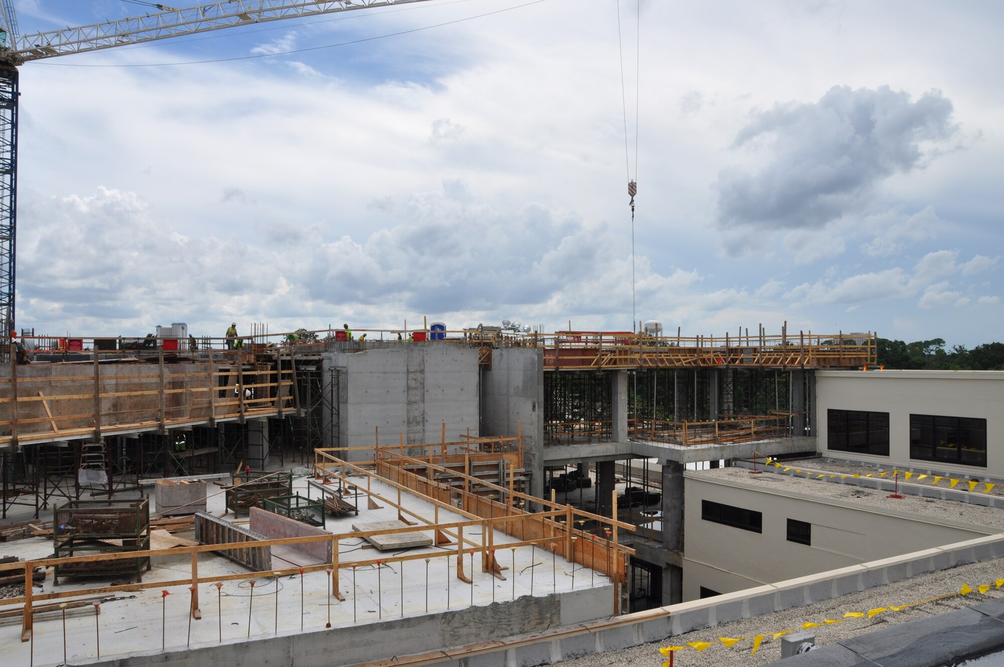 W.G. Yates and Sons Construction Company employees work on the fourth-story floor of the 81st Medical Group Hospital’s new inpatient tower Aug. 11.  They will then erect the roof which will add another 15 feet to the structure’s height.  The final tower will be four stories at its highest point.  The roof of the second story is the foreground.  This portion of the tower will only be two floors and will contain two new operating rooms.  Construction of the new addition is scheduled to be completed in the fall of 2011.  (U.S. Air Force photo by Steve Pivnick)
