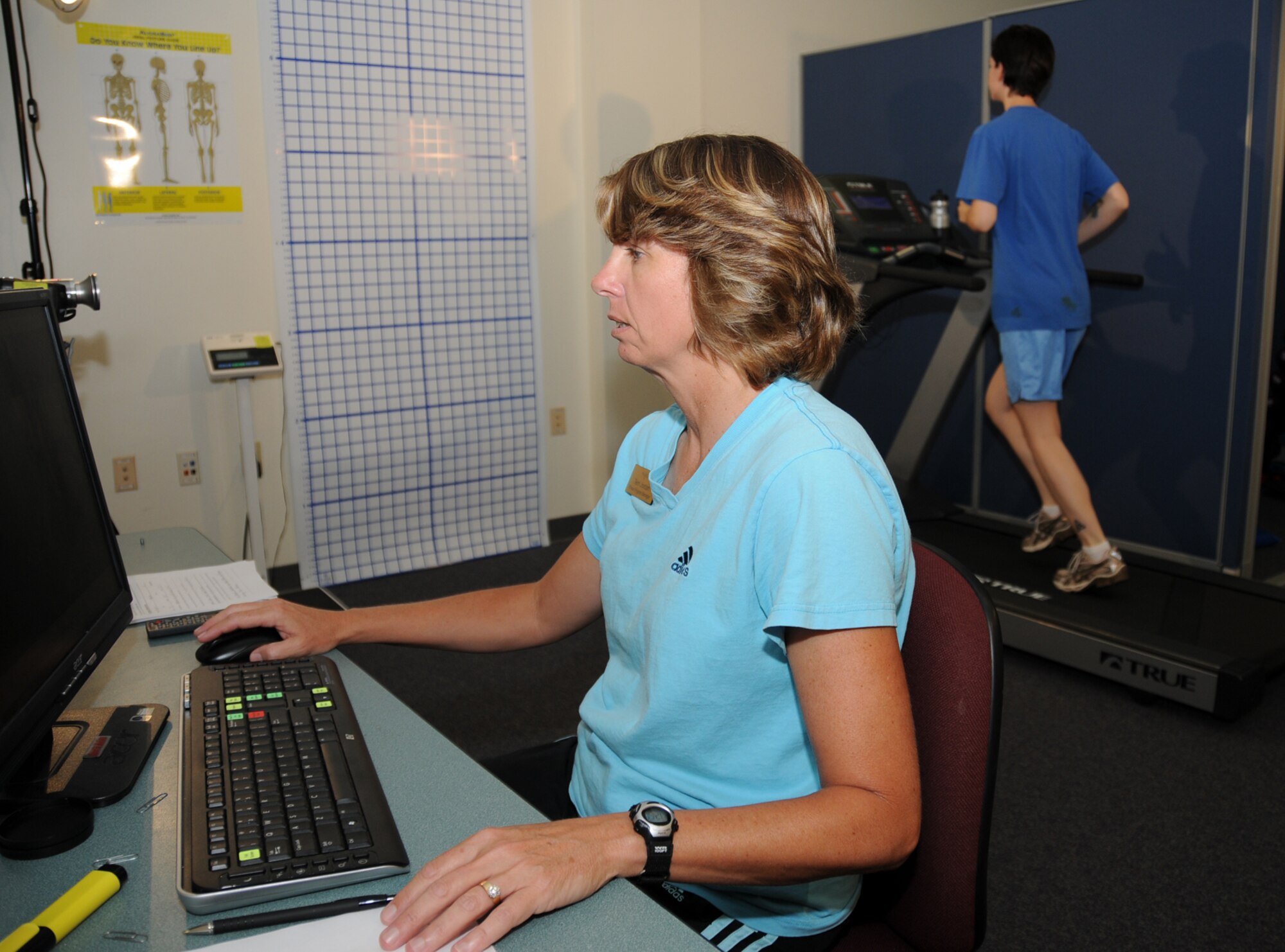 Ms. Jordan conducts a gait analysis on Staff Sgt. Anelina Enright, 85th Engineering Installation Squadron, at the HAWC Oct. 15.  This test analyzes the running stride to increase efficiency and reduce injuries.  (U.S. Air Force photo by Kemberly Groue)