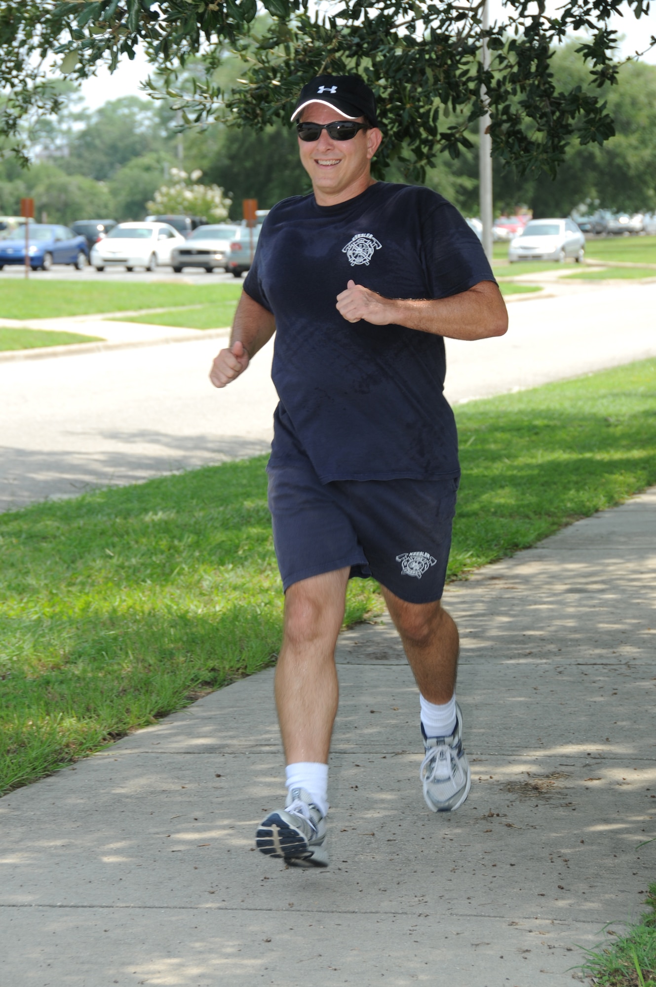Fire chief James Donnett uses proper techniques as he runs along H Street Monday.  (U.S. Air Force photo by Kemberly Groue)