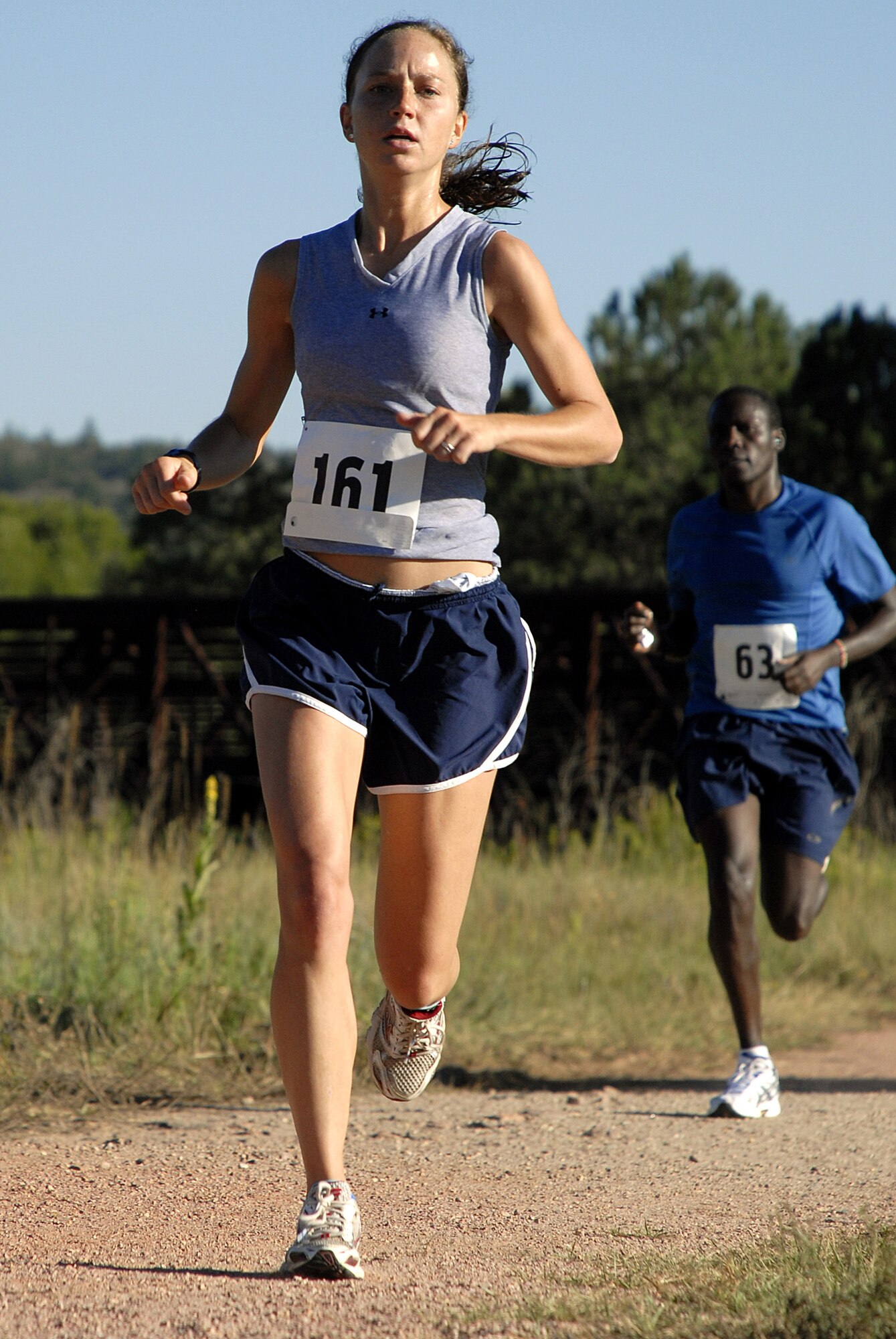 Caitlin Lynch and Stephen Karimi approach the finish line at the Air Force Academy's annual half-marathon Aug. 14, 2010. Lynch finished in 1:31:22 to win the women's 29-and-under bracket. Karimi finished third in the men's 30-39 bracket with 1:31:25. (U.S. Air Force photo/Mike Kaplan)