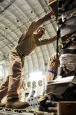Staff Sgt. Manuel Chacon pushes a pallet of halal meals off a C-17 Globemaster III at Bagram Airfield, Afghanistan, on Aug. 2, 2010, during a humanitarian relief mission. The meals are some of the 345,000 that were delivered to Pakistani flood victims since July 31, 2010, to the area that's been hard-hit by monsoon rains in recent days. Sergeant Chacon is a loadmaster from Sun Valley, Calif., and is assigned to the 817th Expeditionary Airlift Squadron at the Transit Center at Manas, Kyrgyzstan. He is currently deployed from the 15th Airlift Squadron at Joint Base Charleston, S.C. (U.S. Air Force Photo/Capt. Chris Sukach, Regional Command-East Public Affairs) 