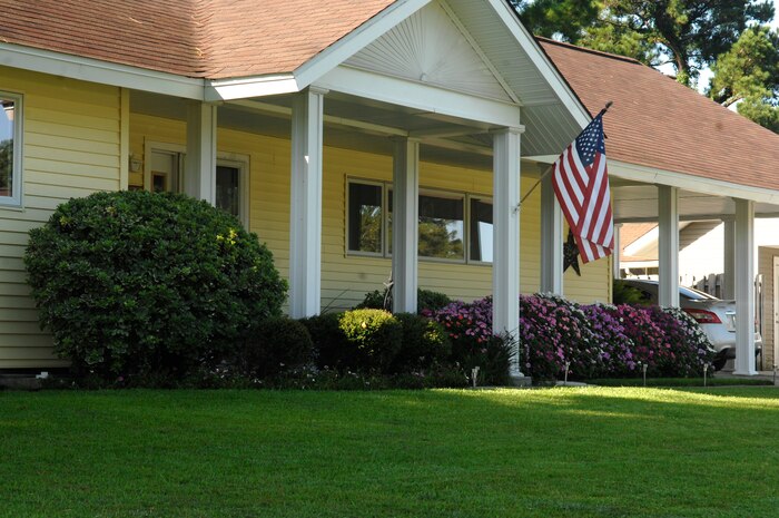 Tech. Sgt. J. Scott Wilcox and his wife Gina began working on their front yard appeal in February and have enjoyed watching it progress through the spring and summer months. Highlights of their curb appeal include their trimmed, green lawn and shrubs, a colorful array of flowing plants, the patriotic flying of the U.S. flag and a display of "Lone Star State" pride at the doorway. (U.S. Air Force Photo/ Senior Airman Nicole Mickle)