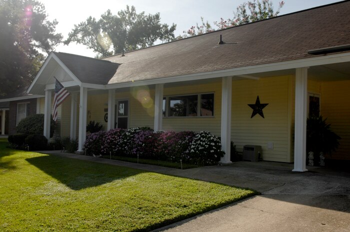 Tech. Sgt. J. Scott Wilcox and his wife were presented the Home of the Month award by 628th Mission Support Group Commander Col. Ben Wham and 628th Air Base Wing Command Chief Master Sgt. Mike Ivey in early August for their well-kept front yard. Monthly winners are chosen from weekly nominees selected throughout the month. (U.S. Air Force Photo/ Senior Airman Nicole Mickle)