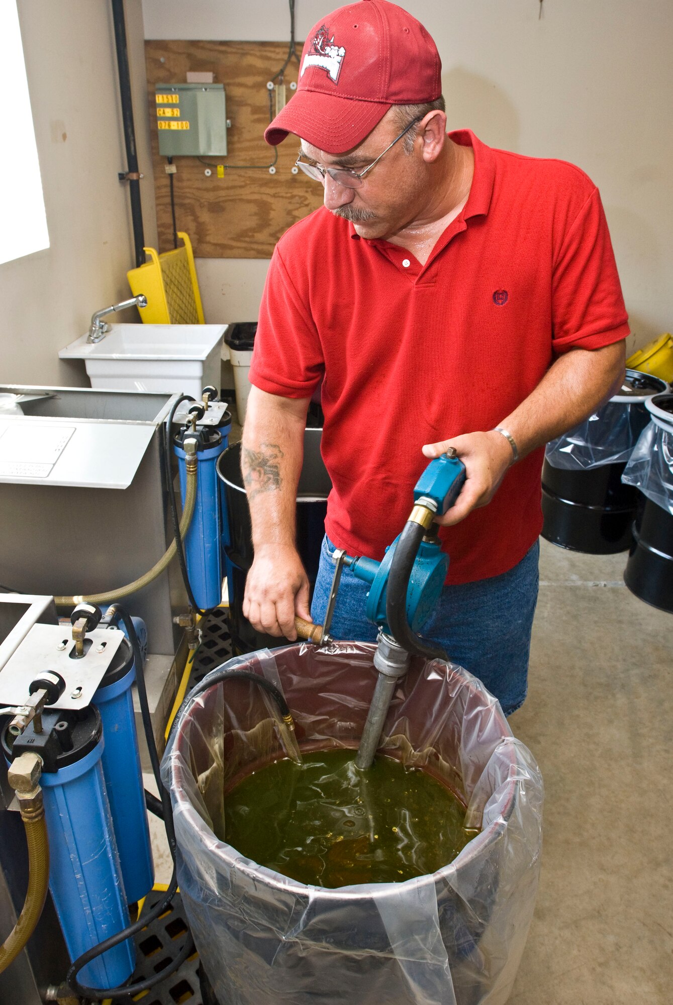 Melvin “Keith” Henson, 19th Civil Engineer Squadron environmental protection specialist, pumps used antifreeze from a drum Aug. 12 for cleaning and recycling. Hazardous Material Office staff members recycle approximately 120 gallons of antifreeze a month. (U.S. Air Force photo by Staff Sgt. Nestor Cruz)